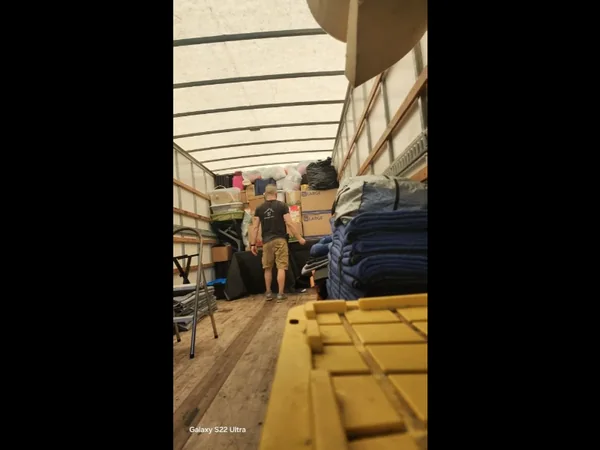 Next Nest team member inside a moving truck with boxes and moving blankets