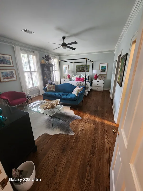 Bed, sofa and furniture arranged inside a bright bedroom