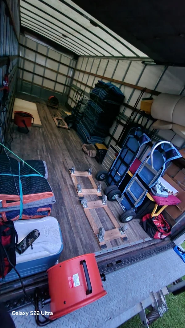 Moving blankets, dollies and straps organized inside a truck