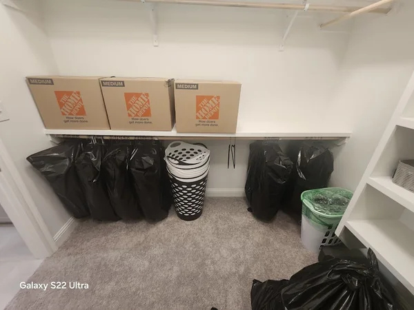 Packed boxes and protected belongings arranged inside a closet